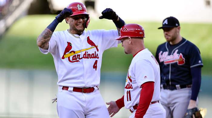 Oct 7, 2019; St. Louis, MO, USA; St. Louis Cardinals catcher Yadier Molina (4) celebrates with first base coach Stubby Clapp (11) after hitting an RBI single in the eighth inning against the Atlanta Braves in game four of the 2019 NLDS playoff baseball series at Busch Stadium. Mandatory Credit: Jeff Curry-USA TODAY Sports